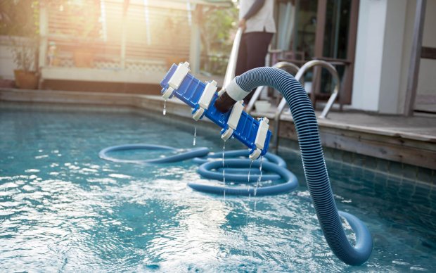 Vacuum cleaning the pool